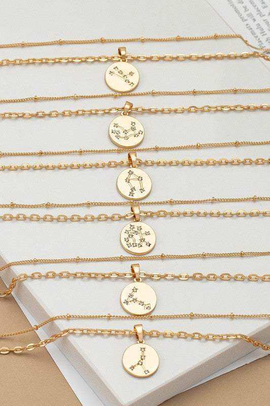 Zodiac Constellation Necklaces lined up on table top 6