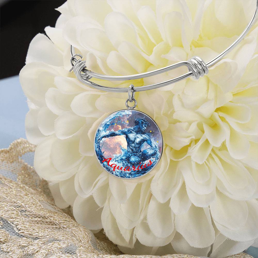 A silver bangle bracelet with a charm featuring an artistic depiction of the Aquarius zodiac sign hangs on a large white flower. The charm displays an image of a figure pouring water and the word "Aquarius" written in red text below. This piece embodies the elegance of personalized jewelry. Introducing the Aquarius Zodiac Bangle Bracelet | Personalized Zodiac Bangle by ShineOn Fulfillment.